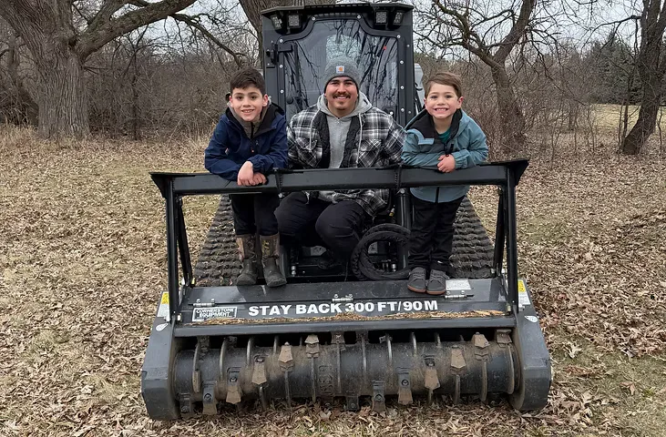 Family owned and operated — the Proper Grounds family on their forestry mulcher in Whitewater, WI