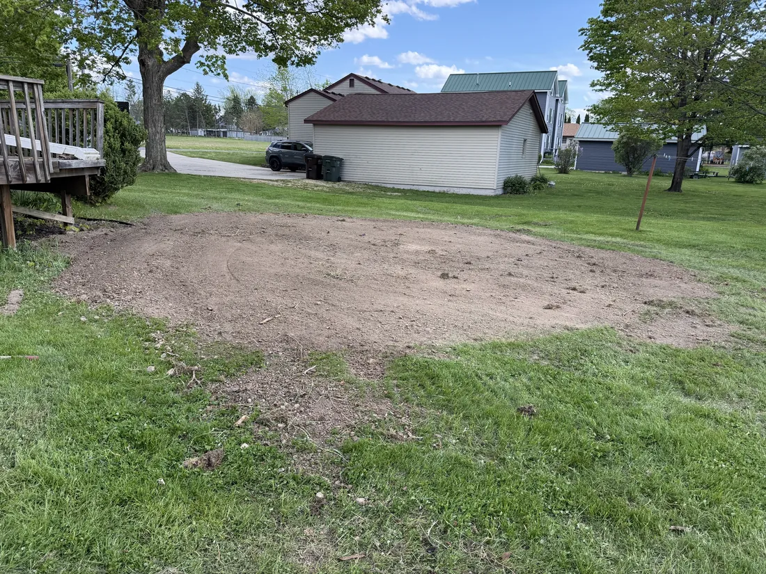 Cleared building pad prepared next to a home